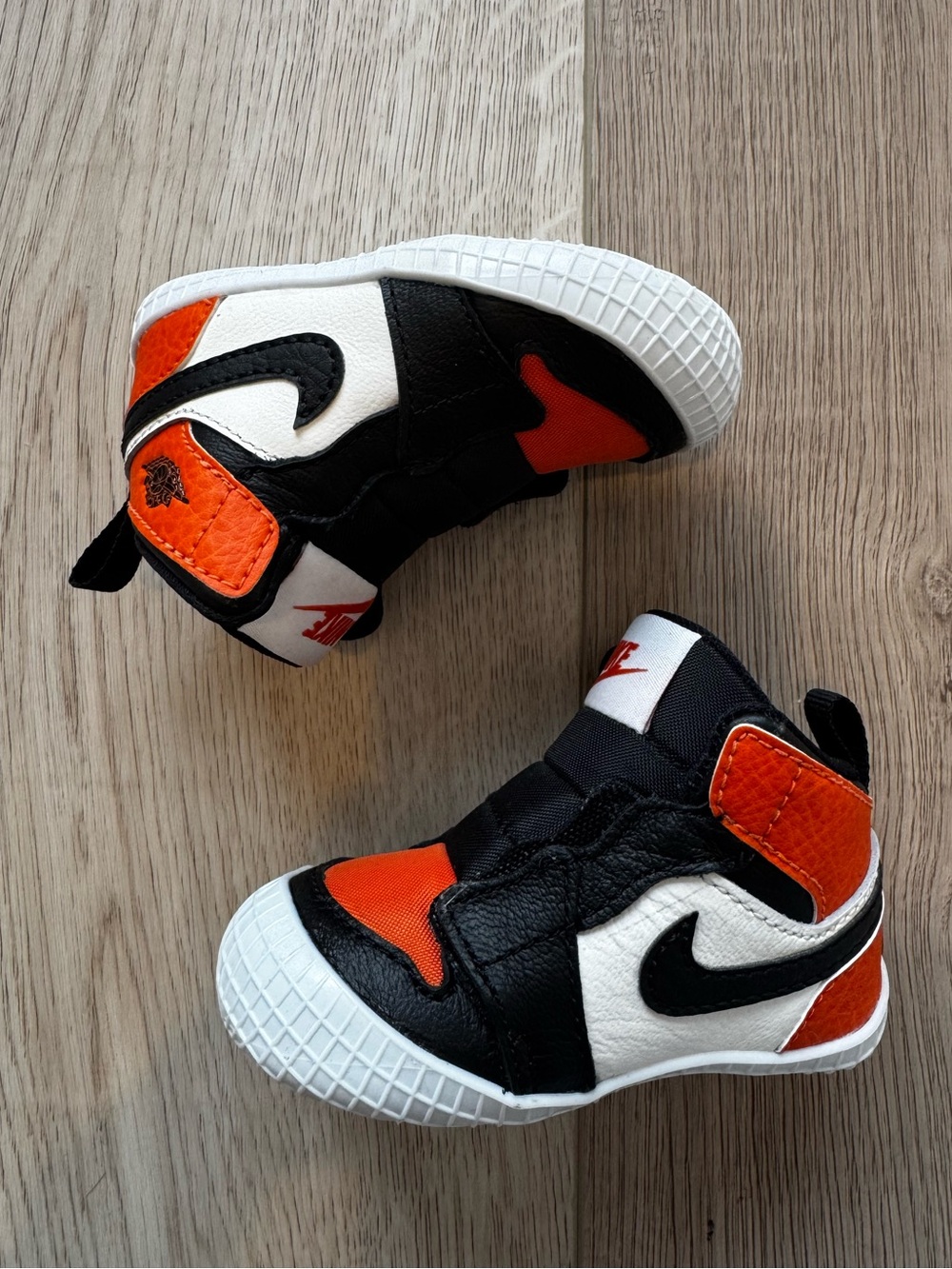Jordan 1 Crib Bootie 3C in Black, White & Orange